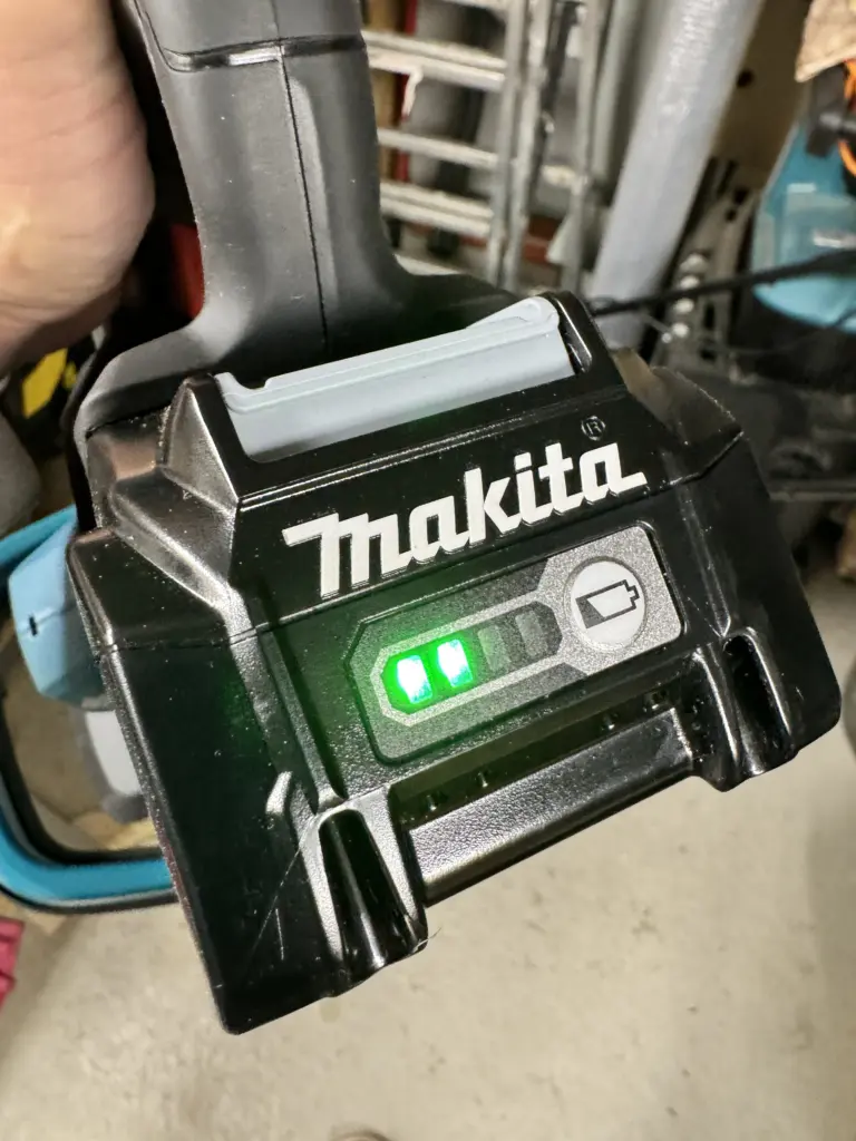 Makita BL4040F Akku mit zwei leuchtenden Balken nach dem Schnitt einer 50 Meter langen Kirschlorbeerhecke