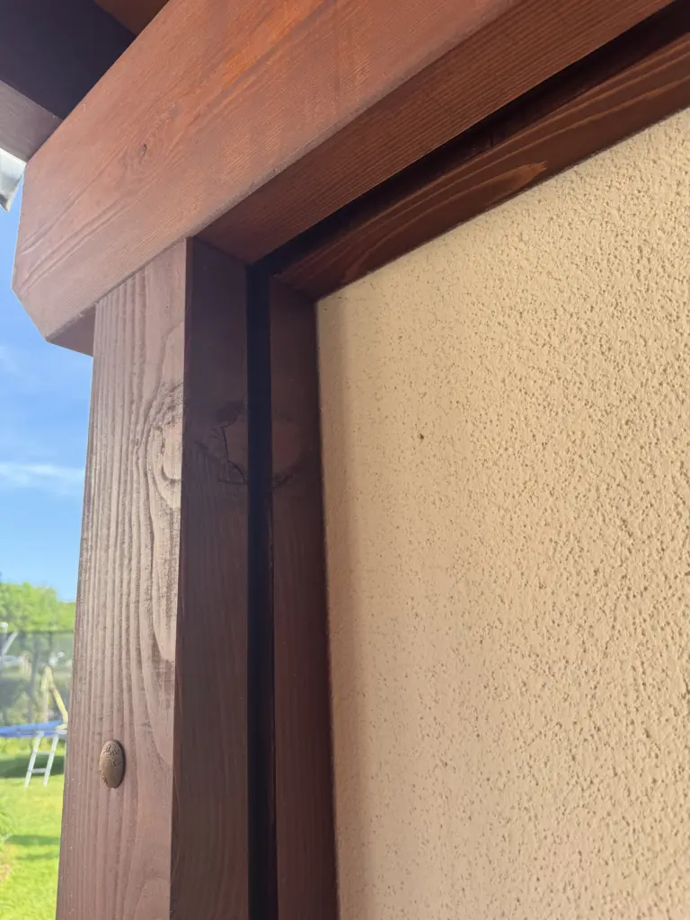 Montierter Schlossschraubenkopf am Holzpfosten meines Carports neben der Betonfertiggarage